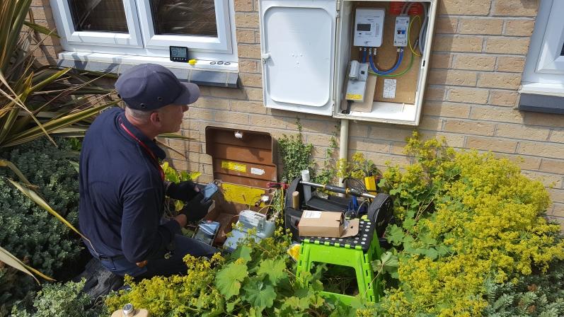 Scottish Power engineer installing a smart gas and smart electricity meter